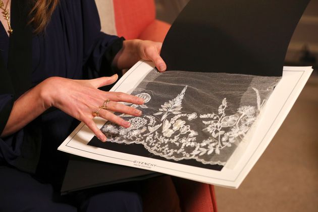 Clare Waight Keller, designer at Givenchy, holds lace as she gives an interview the day after the Duchess of Sussex walked down the aisle.