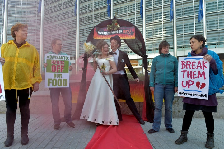 Activists from Friends of the Earth Europe stage a "marriage made in hell" protest against the Monsanto-Bayer merger outside the European Commission in Paris.