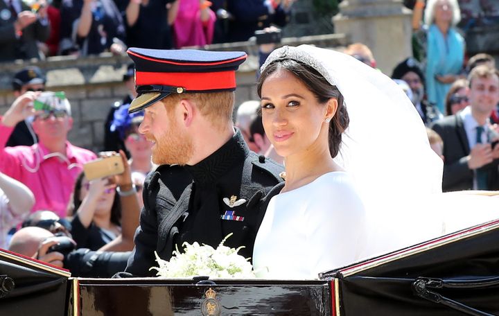 Prince Harry, Duke of Sussex and the Duchess of Sussex in the Ascot Landau carriage during the procession after getting married at St George's Chapel, Windsor Castle on May 19, 2018 in Windsor, England.