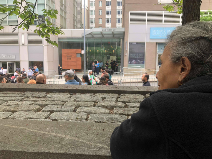 The author's abuela watches the protest outside Schlossberg's apartment building.