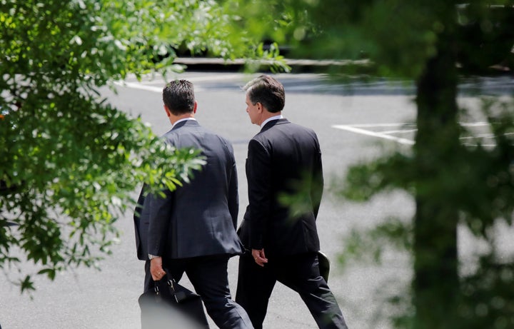 FBI Director Christopher Wray (right) arrives at the West Wing of the White House for a meeting with President Donald Trump on May 21, 2018.