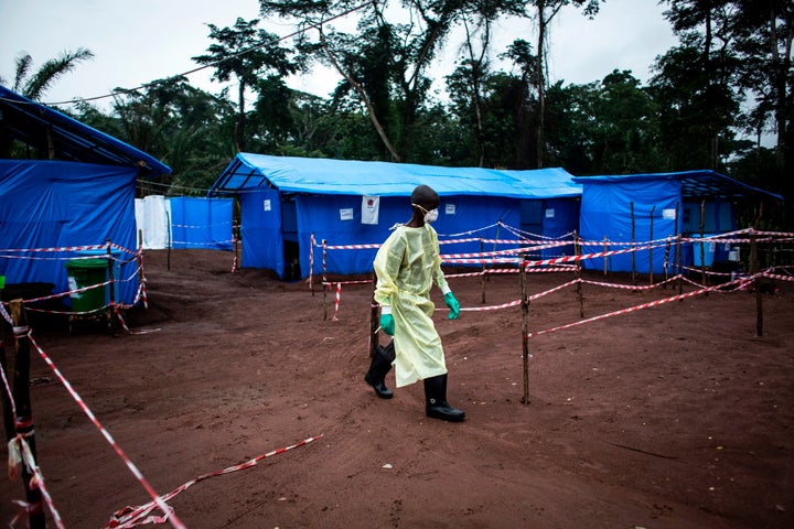 A health worker walks through an Ebola quarantine unit on June 13, 2017, in the village of Muma, after a case of Ebola was confirmed there.