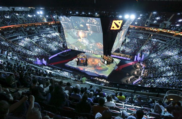 Fans watch a competition during The International Dota 2 Championships at Key Arena in Seattle, Washington August 8, 2015.