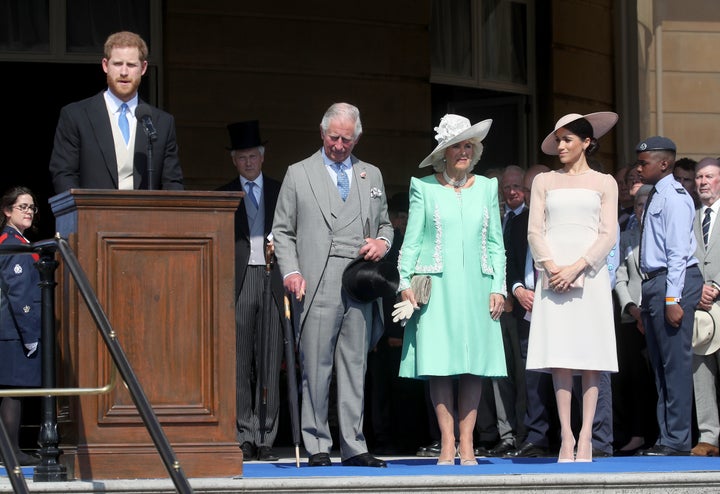 Prince Harry, Duke of Sussex, giving a speech next to Prince Charles, Camilla, Duchess of Cornwall and Meghan, Duchess of Sussex.