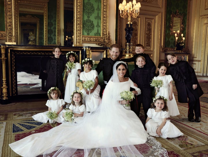 The newlyweds pose for a photograph with their bridesmaids and pageboys.