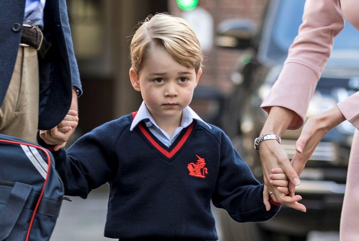 Helen Haslem, head of the lower school and Britain's Prince William hold Prince George's hands as he arrives for his first day of school at Thomas's school in Battersea, London, September 7, 2017