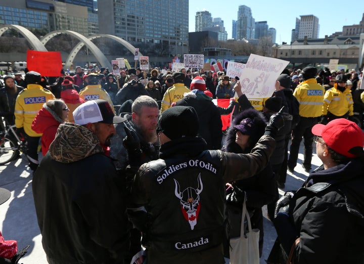 Members of the Soldiers of Odin Canada are faced by counter-protesters as they attend a rally.
