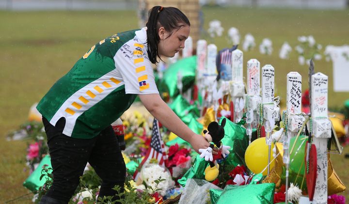 A student mourns those killed in the recent shooting at Santa Fe High School.