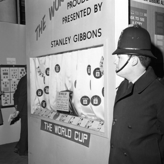 A police officer stands next to the display case in the Central Hall Westminster from which the World Cup was stolen