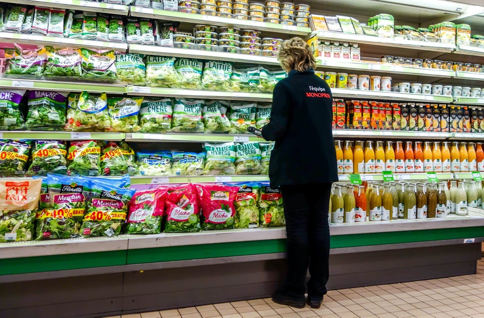 An employee checking shelves in a French supermarket. A 2011 study found that France spent as much to clean up water polluted through conventional farming, mainly from pesticide use, as it did on groceries.