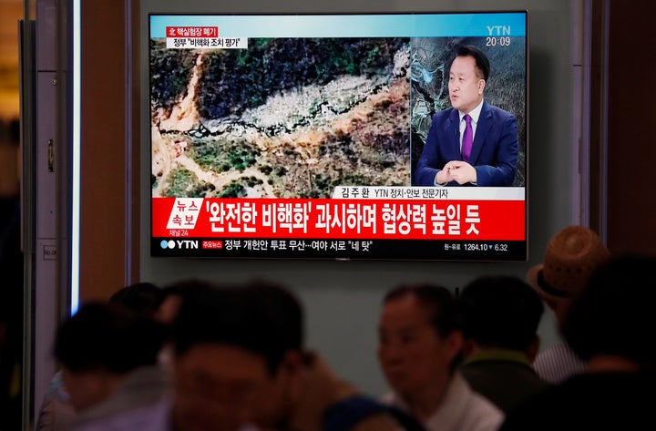 People watch a news report in Seoul on the dismantling of the Punggye-ri nuclear testing site.