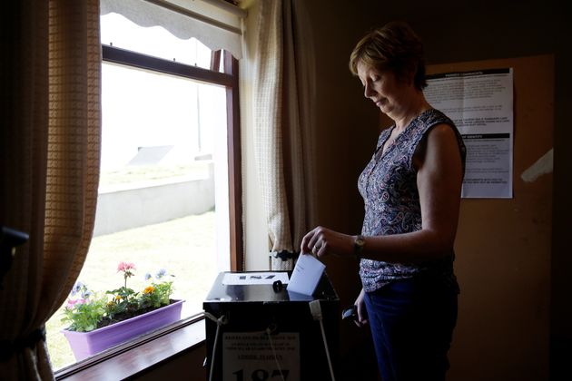 A woman casts her vote in the abortion referendum on the sparsely populated Gola Island, where polls opened a day early 