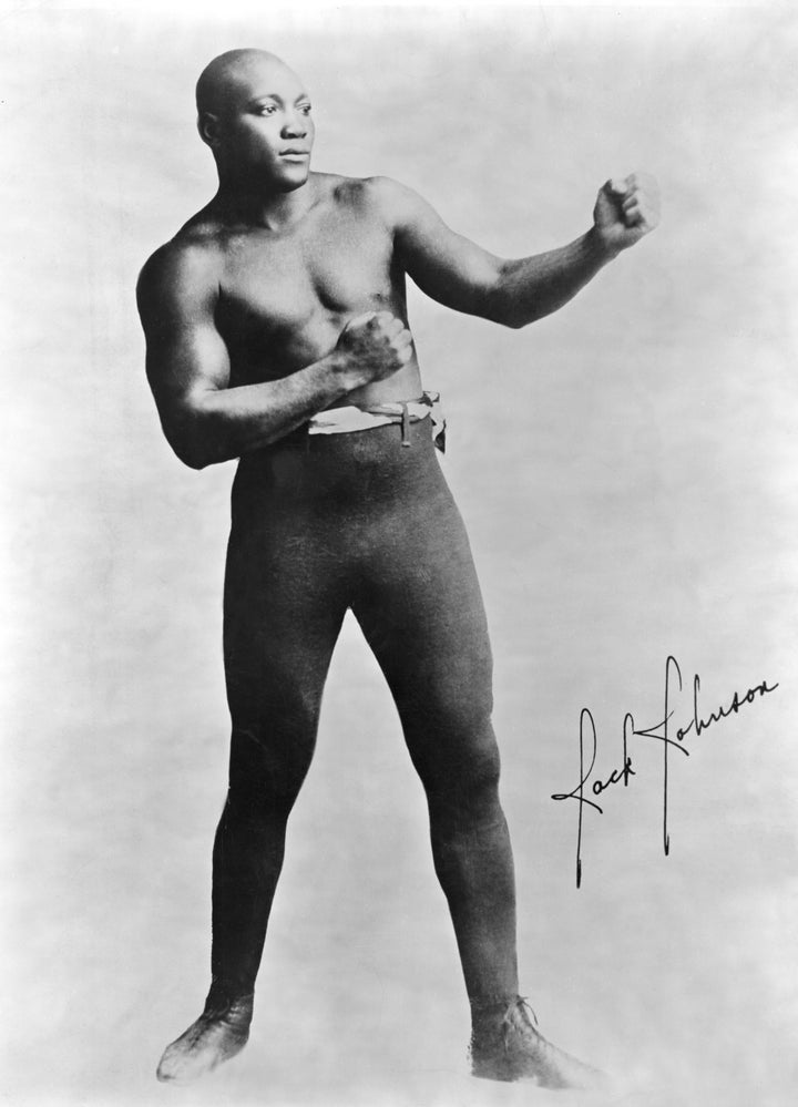 Jack Johnson won his heavyweight boxing world champion title by knocking out Canadian boxer Tommy Burns in 1908.