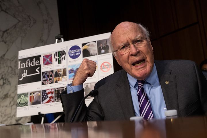 Sen. Patrick Leahy (D-Vt.) questions witnesses during a committee hearing with examples of Russian-created Facebook pages behind him, Oct. 31, 2017.