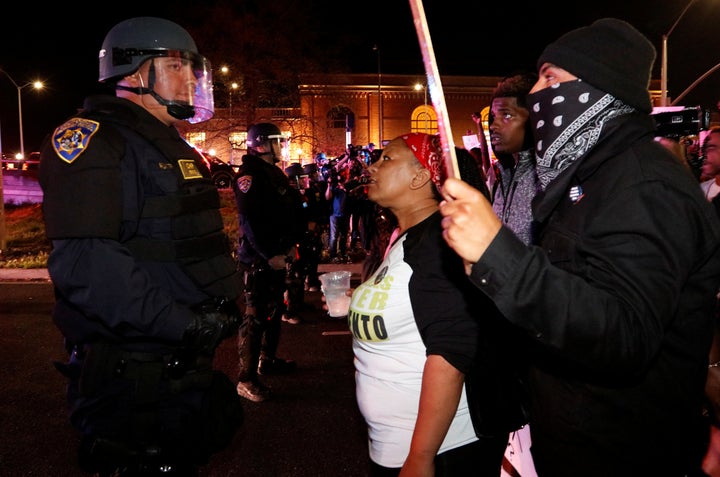 Demonstrators face off with California Highway Patrol officers as they protest the police shooting of Stephon Clark, in Sacramento, California, on March 30, 2018.