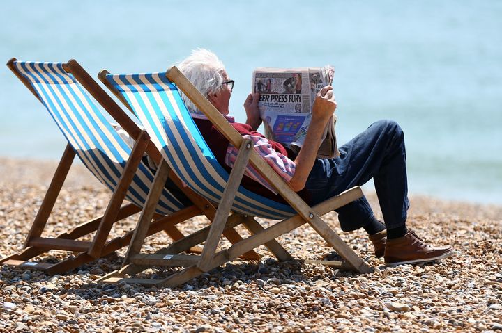 People enjoy the sunshine on the beach in Brighton, East Sussex, this month. 