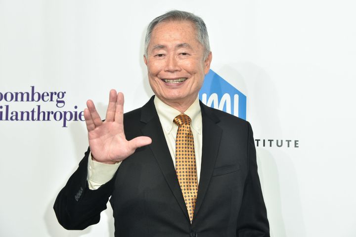 George Takei gives the Vulcan salute on a red carpet in 2016. 