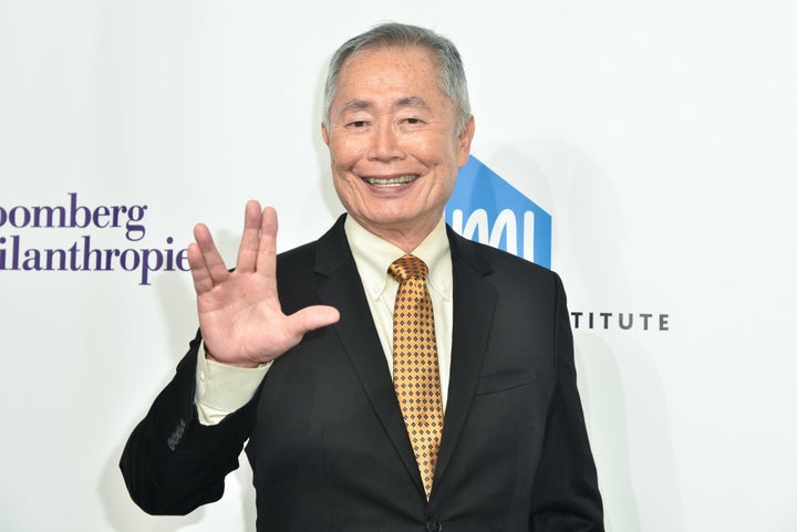 George Takei gives the Vulcan salute on a red carpet in 2016.