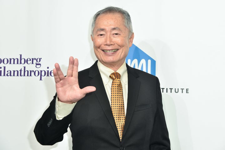 George Takei gives the Vulcan salute on a red carpet in 2016. 