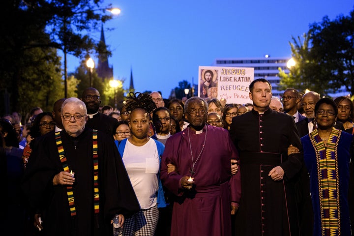 Bishop Michael Curry (C) leaves the National City Christian Church to march to the White House for a vigil on May 24, 2018.