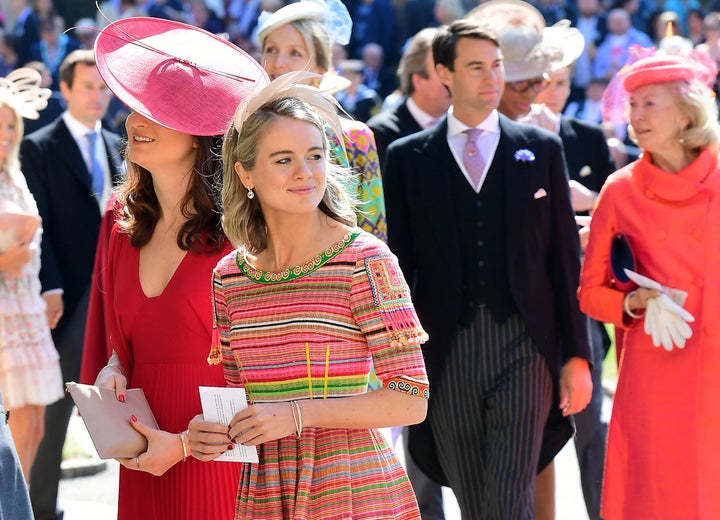 Cressida Bonas wears a bright striped dress with the small feathered fascinator.