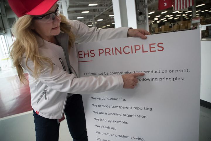 Laurie Shelby, Tesla’s vice president for environment, health and safety, points to the principles of her department listed on a placard at the car plant in Fremont, Calif. 