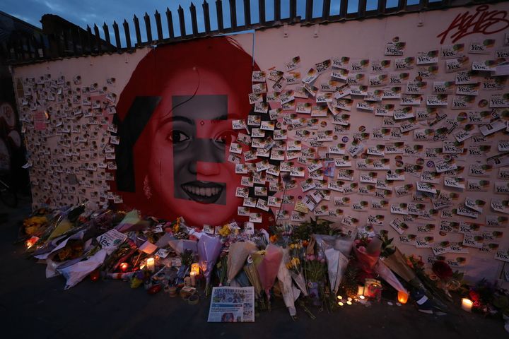 Candle and flowers are placed in front of a mural of Savita Halappanavar in Dublin