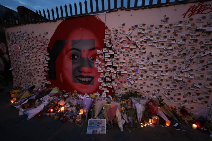 Candle and flowers are placed in front of a mural of Savita Halappanavar in Dublin