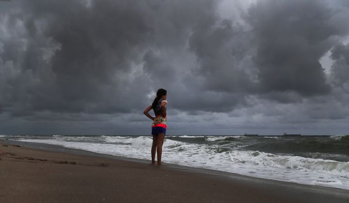 Alicia Herrera, 10, visiting from Germany, doesn't let dark clouds ruin her day at the beach in Fort Lauderdale, Florida, on Friday.