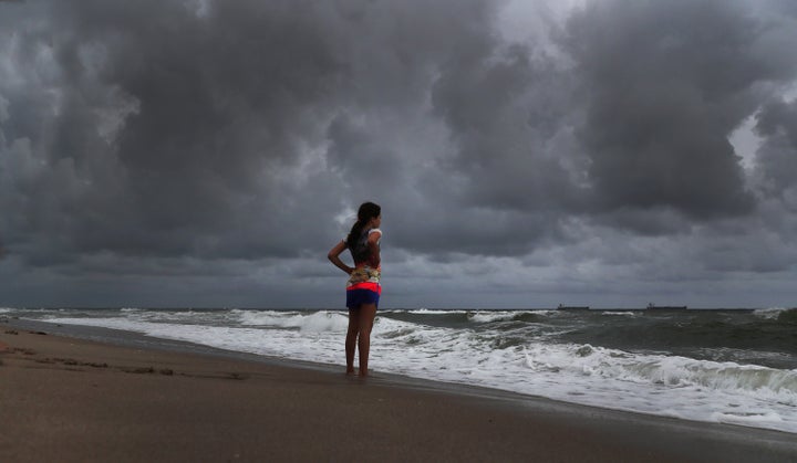 Alicia Herrera, 10, visiting from Germany, doesn't let dark clouds ruin her day at the beach in Fort Lauderdale, Florida, on Friday.