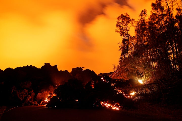 A lava flow from the Kilauea volcano illuminates the night sky near Pahoa, Hawaii.