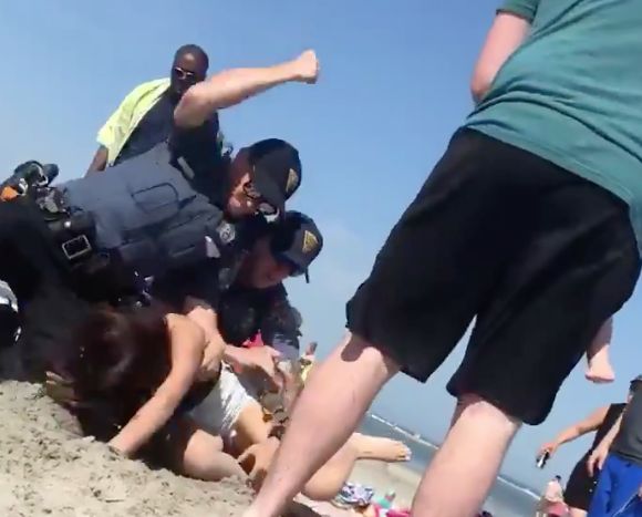 The woman said the officers had first approached her on the beach because they’d spotted her with some alcohol. She claimed the alcohol was unopened and she passed a breathalyzer test.