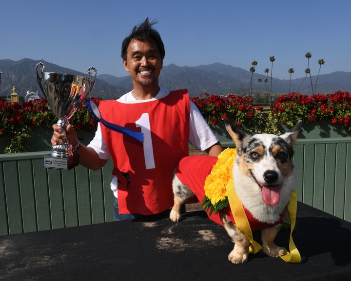 Rick Garcia celebrates with his dog, Roi, after winning the SoCal Corgi Nationals.