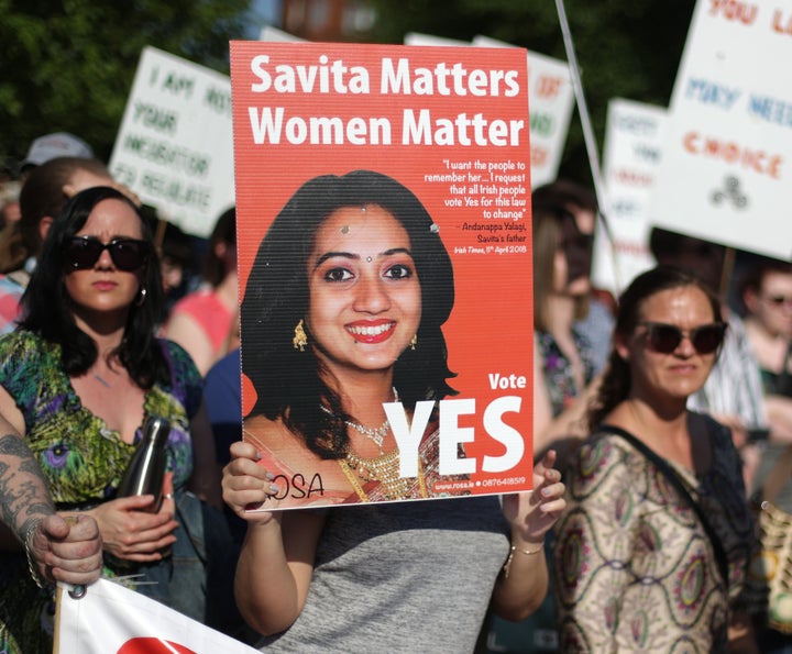 A woman holds a poster of Savita Halappanava at Belfast City Hall.