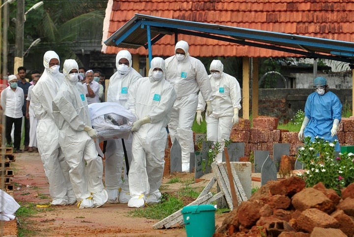 Doctors and relatives wearing protective gear carry the body of a victim of the brain-damaging Nipah virus, during his funeral in Kozhikode, in the southern Indian state of Kerala, India, on May 24.