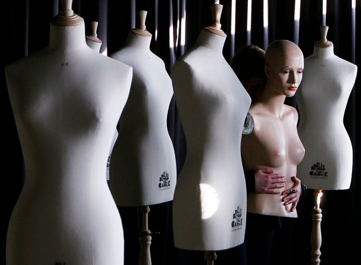 A fashion student holds the body part of a dummy during a media event for the unveiling of plus size mannequins at Edinburgh College of Art, Scotland 