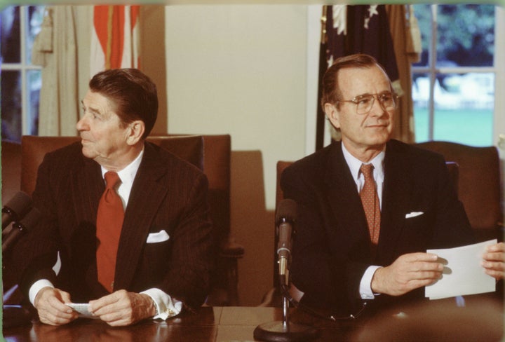 President Ronald Reagan and Vice President George H.W. Bush hold a meeting in the White House Cabinet Room, circa 1983.