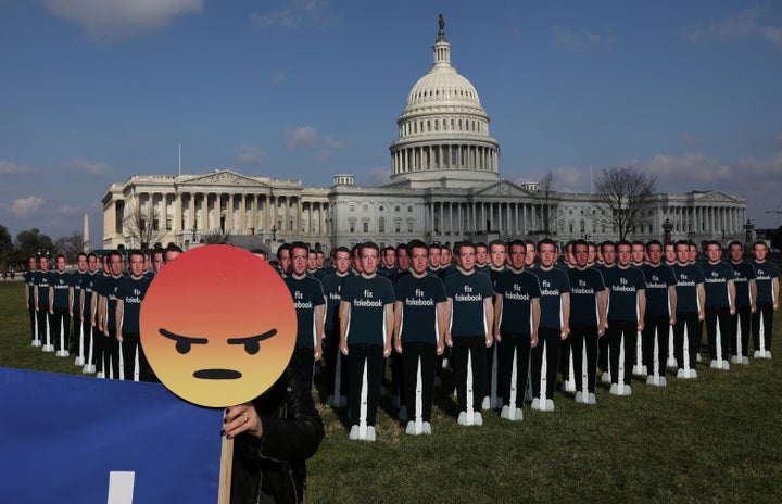 Dozens of cardboard cut-outs of Facebook CEO Mark Zuckerberg are placed outside of the U.S. Capitol Building as par