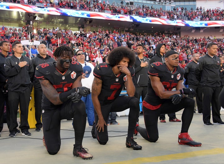 San Francisco 49ers outside linebacker Eli Harold (58), quarterback Colin Kaepernick (7) and free safety Eric Reid (35) kneel in protest during the national anthem before an NFL game at Levi's Stadium on Oct. 16, 2016.