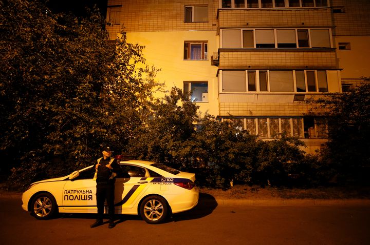 A Ukrainian police officer guards near an apartment block where Russian journalist Arkady Babchenko was shot