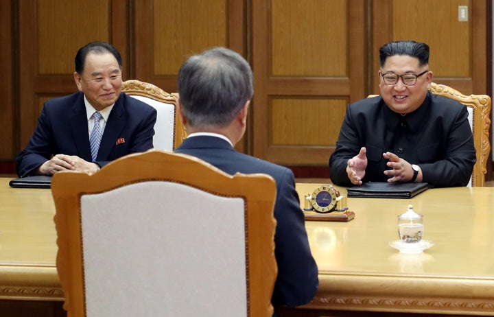 Kim Yong Chol (left) and Kim Jong Un speaking with South Korean President Moon Jae In at a meeting at the truce village of Panmunjom on May 26, 2018.