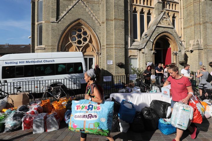 People leave donations outside the Notting Hill Methodist Church near the burning 24 storey residential Grenfell Tower block.