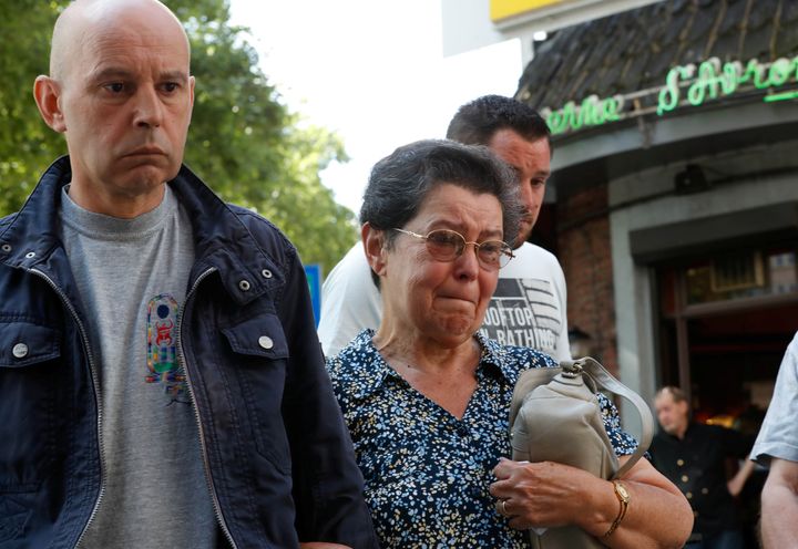 Bernadette Hennart, mother of late police officer Soraya Belkacemi, accompanied by her son Kamel Belkacemi (L), pays tribute to her daughter who was killed on May 29 during a shooting in Liege, Belgium.