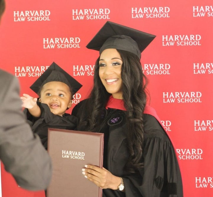 Briana Williams graduates from Harvard Law School, accompanied by her daughter, Evelyn.