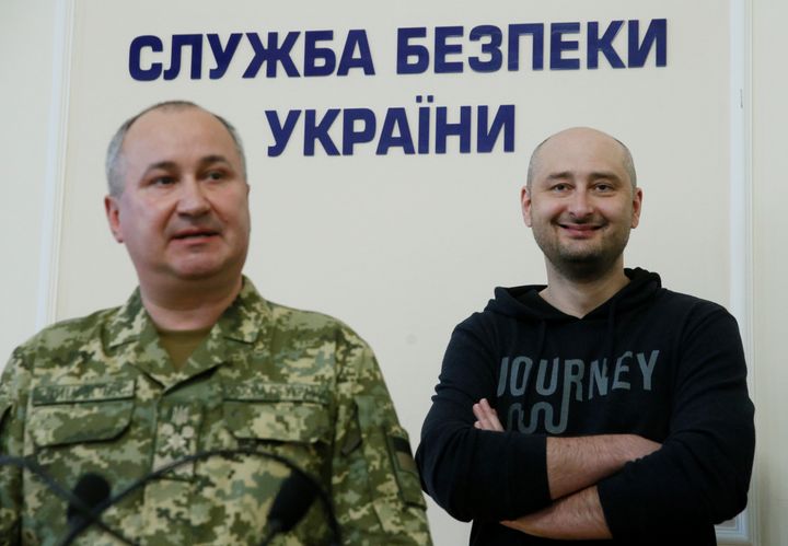 Russian journalist Arkady Babchenko, right, who was reported murdered in the Ukrainian capital, and head of Ukrainian State Security Service, Vasily Gritsak, attend a news briefing in Kiev.
