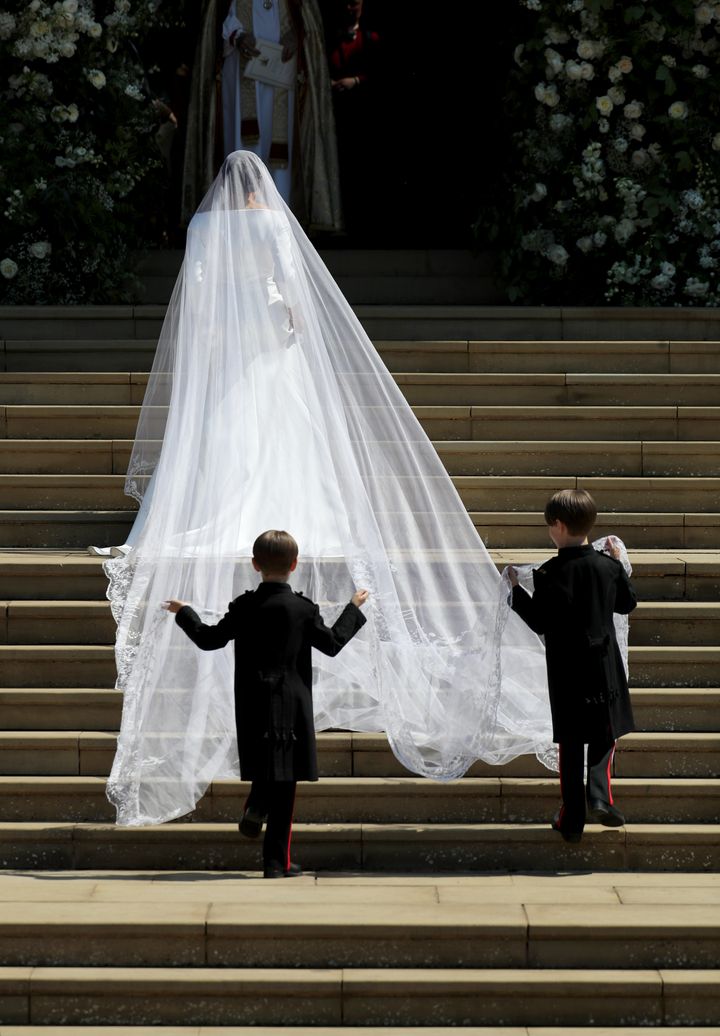Pageboys John and Brian Mulroney follow Markle into the chapel, carrying her gorgeous 16-foot veil.