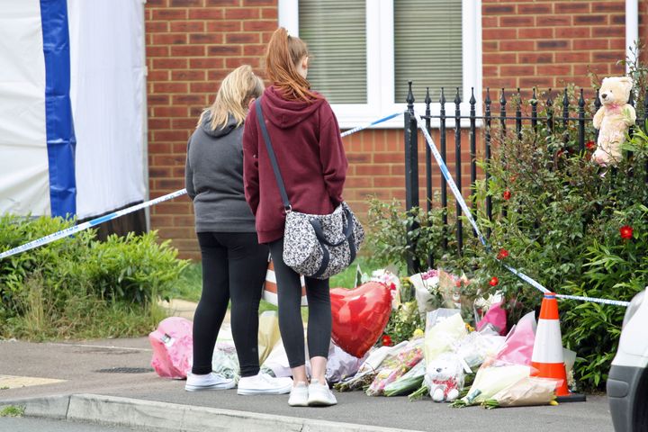 People pay their respects in Dexter Way, Gloucester where the bodies of 31-year-old Laura Mortimer and her 11-year-old daughter Ella Dalby were found on Bank Holiday Monday.