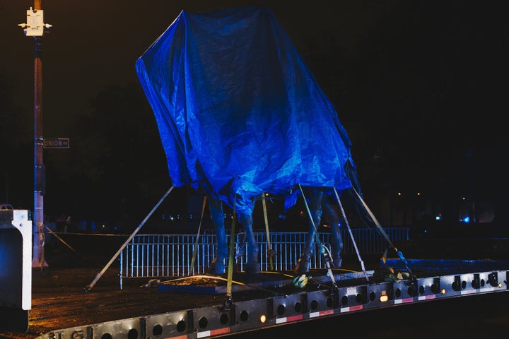 The statue of Gen. Nathan Bedford Forrest sits under a tarp on a truck after being removed from a Memphis park on Dec. 20, 2017.