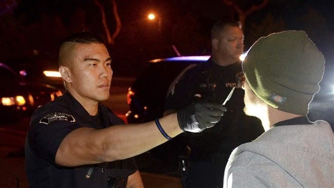 Fullerton, California, police officer Jae Song conducts a field sobriety test on a driver suspected of driving while impaired