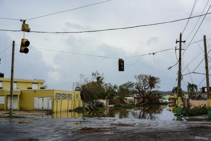 An intersection is flooded with water from a nearby lake after Hurricane Maria at Lagos de Plata in Levittown, Puerto Rico on September 21, 2017.